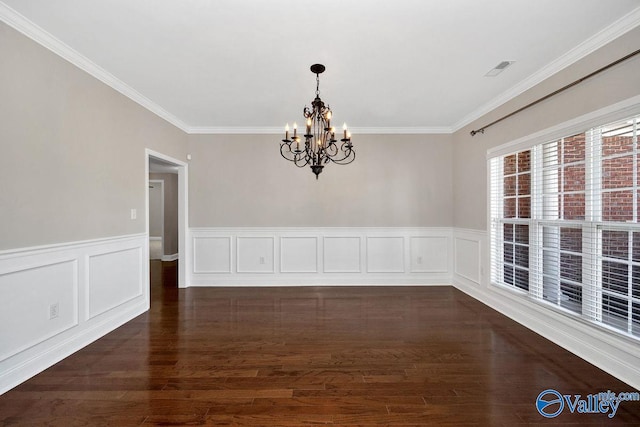 unfurnished dining area featuring visible vents, dark wood-type flooring, a notable chandelier, ornamental molding, and a decorative wall