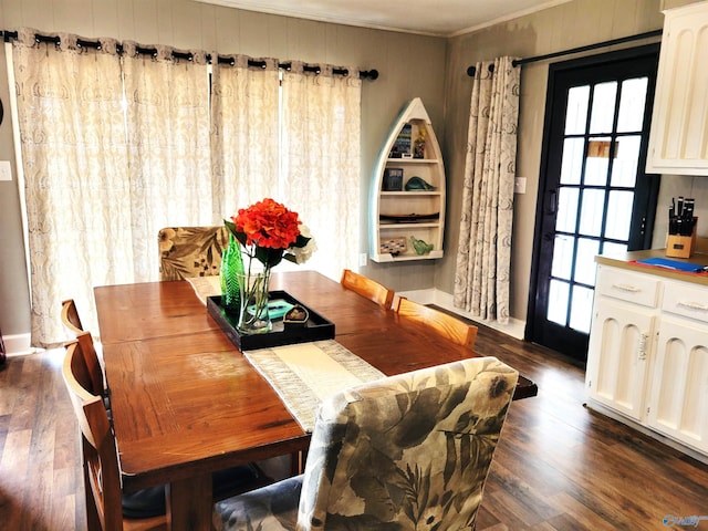 dining area featuring dark wood-type flooring and ornamental molding