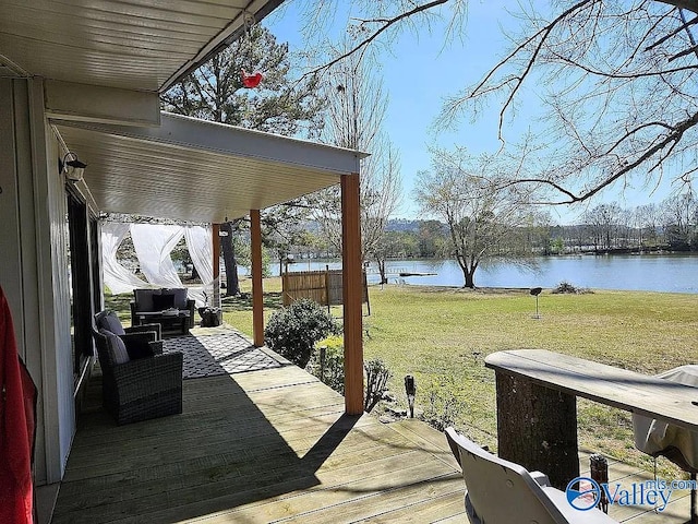 wooden deck featuring a lawn and a water view