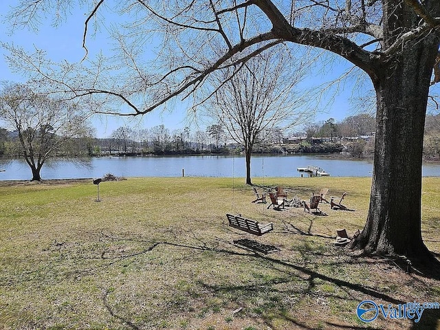 view of yard featuring an outdoor fire pit and a water view