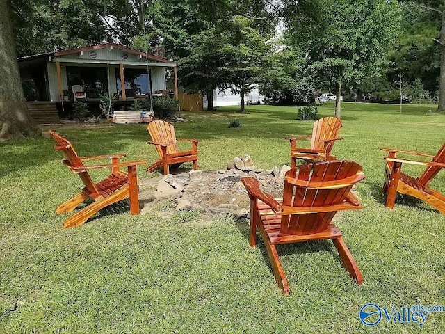 view of yard with a fire pit