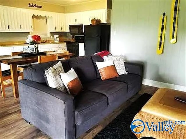 living room with baseboards and wood finished floors