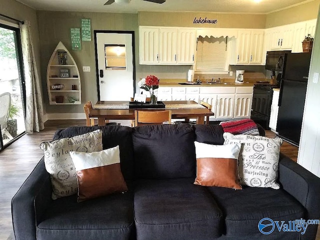 living room with wood finished floors and a ceiling fan