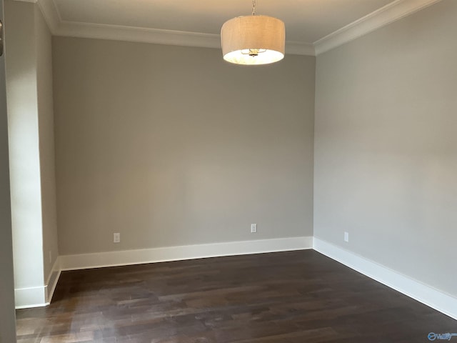 empty room with dark wood-type flooring and ornamental molding