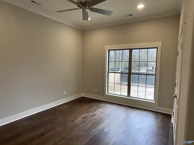 spare room with crown molding, ceiling fan, and dark hardwood / wood-style flooring