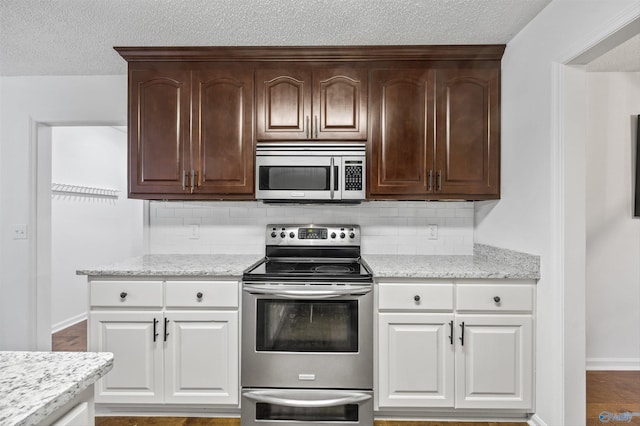138 Spring Farm Rd, Huntsville, AL 35811 - kitchen with stainless steel appliances, decorative backsplash, a textured ceiling, white cabinets, and light stone countertops