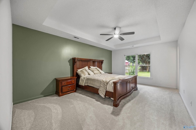 138 Spring Farm Rd, Huntsville, AL 35811 - bedroom with a raised ceiling, light carpet, ceiling fan, and a textured ceiling