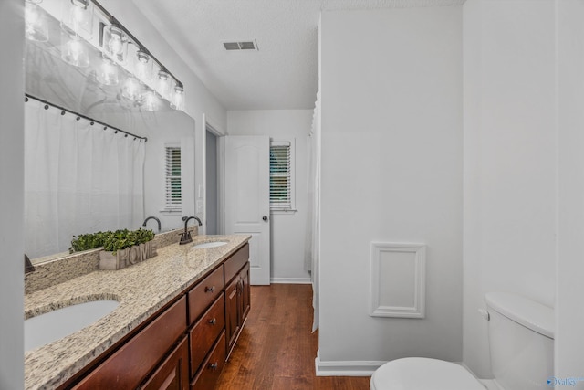 138 Spring Farm Rd, Huntsville, AL 35811 - full bath with wood finished floors, double vanity, and a textured ceiling