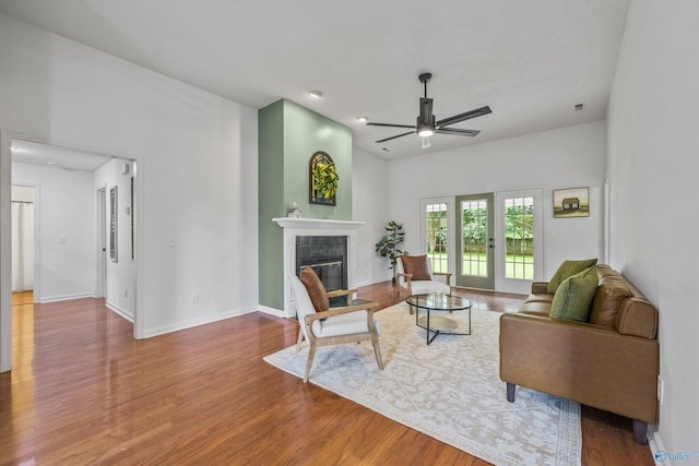 138 Spring Farm Rd, Huntsville, AL 35811 - living area with a tile fireplace, ceiling fan, and wood finished floors