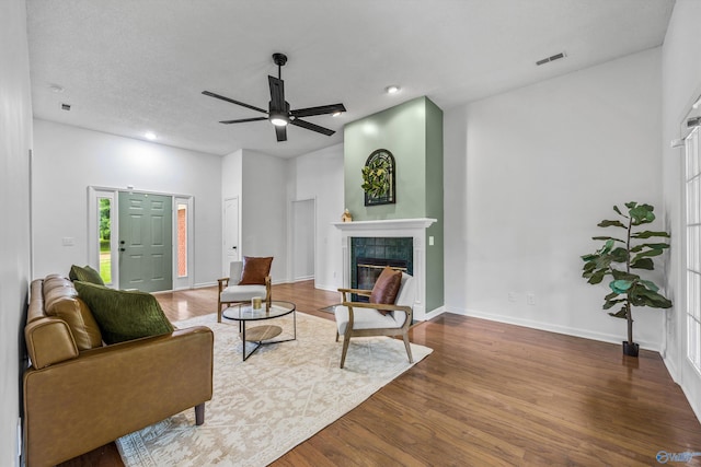 138 Spring Farm Rd, Huntsville, AL 35811 - living area featuring a tiled fireplace, ceiling fan, wood finished floors, and recessed lighting