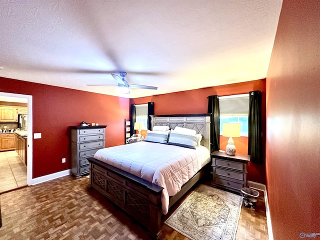 175 County Road 23, Leesburg, AL 35983 - bedroom featuring baseboards, ceiling fan, multiple windows, connected bathroom, and a textured ceiling