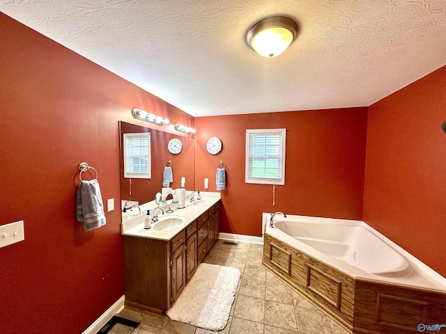 175 County Road 23, Leesburg, AL 35983 - bathroom with double vanity, a garden tub, baseboards, tile patterned flooring, and a textured ceiling
