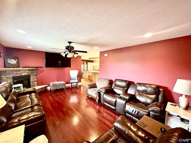 175 County Road 23, Leesburg, AL 35983 - living room with ceiling fan, a stone fireplace, wood finished floors, recessed lighting, and a textured ceiling