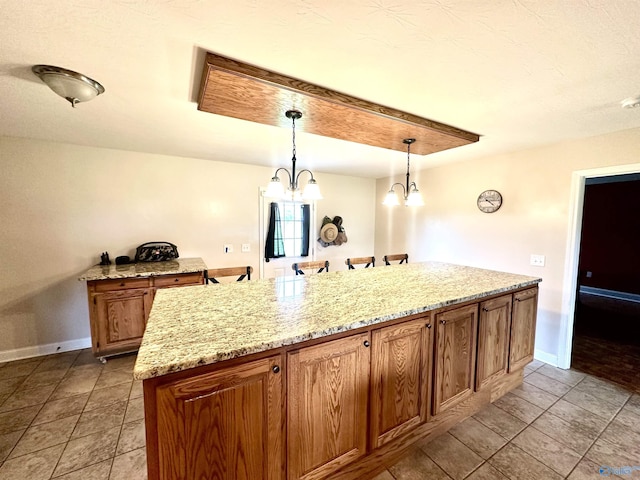 175 County Road 23, Leesburg, AL 35983 - kitchen with baseboards, pendant lighting, and light stone counters