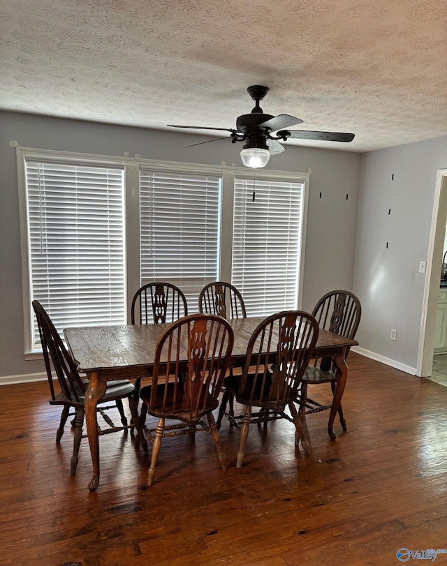 dining room with wood-type flooring, baseboards, ceiling fan, and a textured ceiling