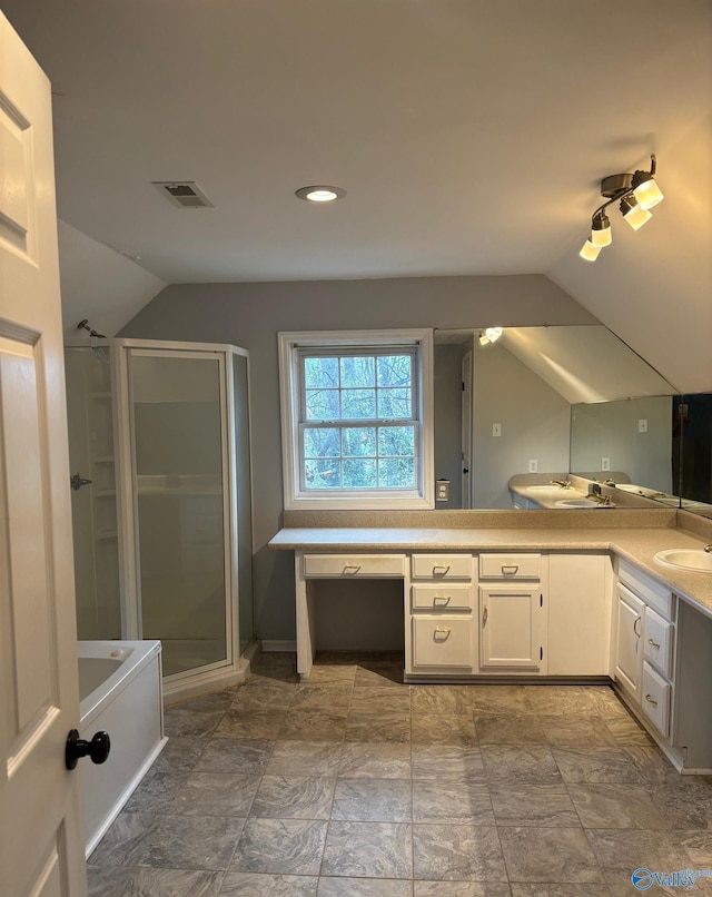 bathroom featuring double vanity, visible vents, a stall shower, vaulted ceiling, and a sink