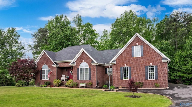 152 W Dr, Fyffe, AL 35971 - view of front of home with brick siding, a front lawn, and roof with shingles