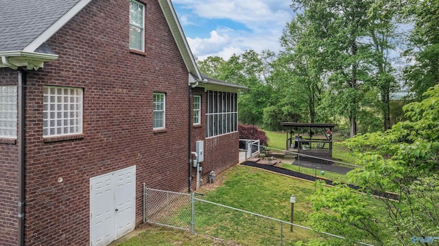 152 W Dr, Fyffe, AL 35971 - view of home's exterior featuring brick siding, roof with shingles, and a gate