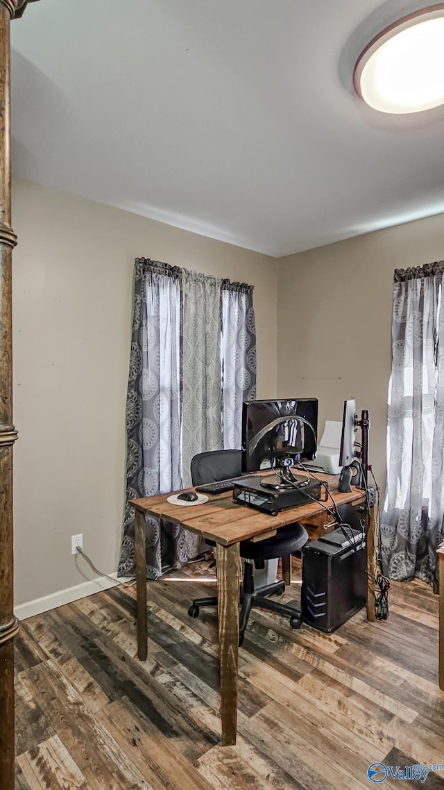 home office with baseboards and wood finished floors