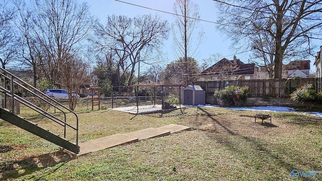 view of yard featuring fence and a fire pit