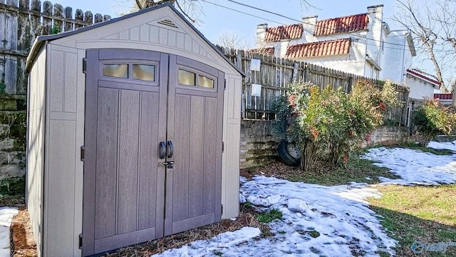 view of shed featuring fence