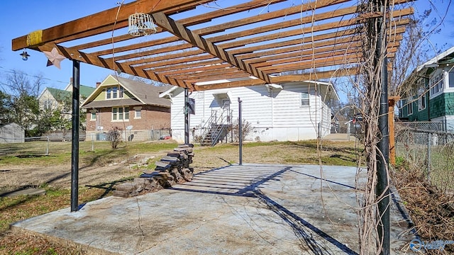 view of patio featuring fence and a pergola