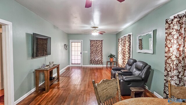 sitting room with baseboards, ceiling fan, and hardwood / wood-style floors