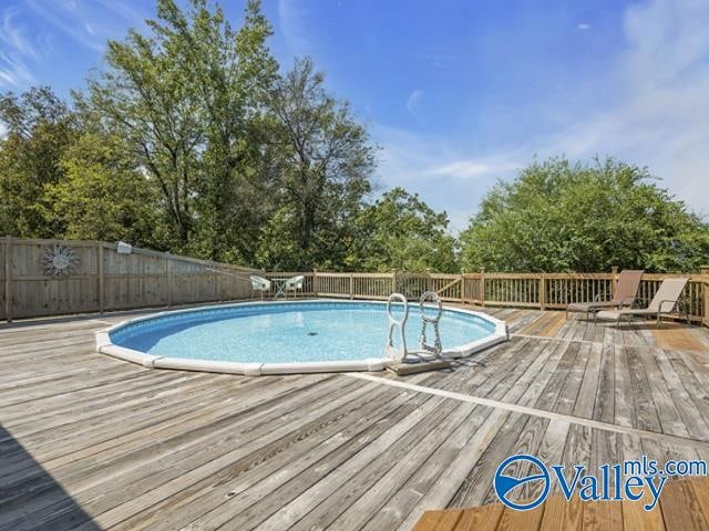view of swimming pool featuring a wooden deck