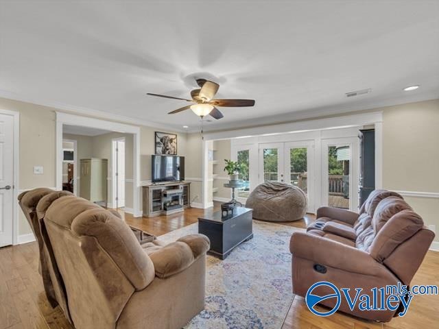 living room featuring light hardwood / wood-style floors, french doors, and ceiling fan
