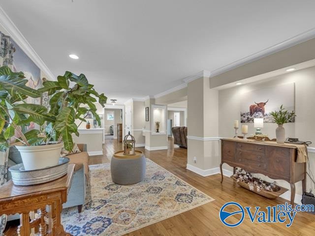 living room featuring ornamental molding and hardwood / wood-style flooring