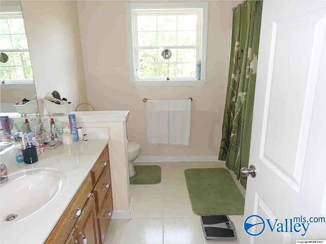 430 Timber Trl, Ashville, AL 35953 - bathroom with tile patterned flooring, vanity, baseboards, toilet, and a shower with shower curtain