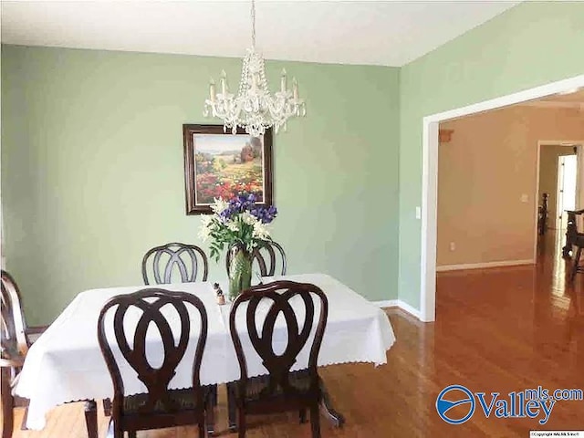 430 Timber Trl, Ashville, AL 35953 - dining area with a chandelier, wood finished floors, and baseboards