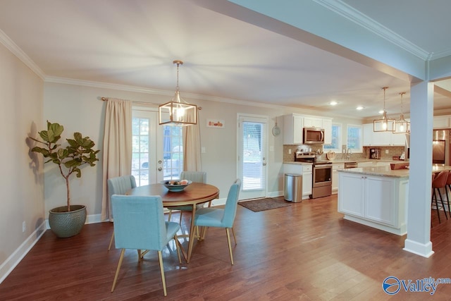 dining area featuring crown molding and dark hardwood / wood-style floors