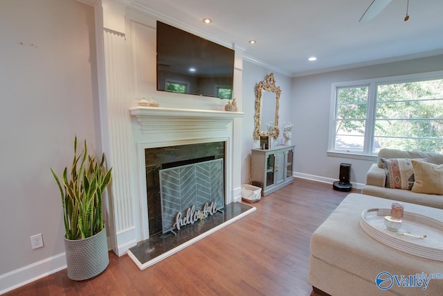 living room with crown molding and wood-type flooring