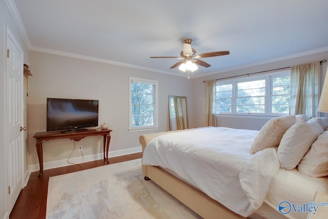 bedroom with crown molding, ceiling fan, and hardwood / wood-style flooring