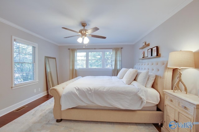 bedroom featuring crown molding, ceiling fan, hardwood / wood-style floors, and multiple windows