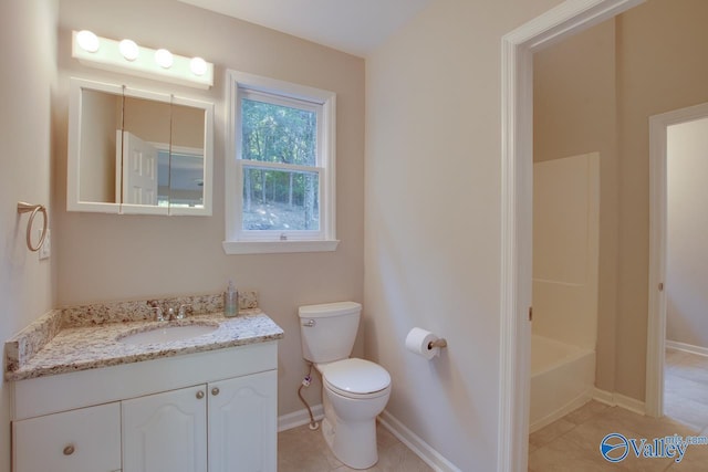 bathroom featuring tile patterned floors, vanity, and toilet