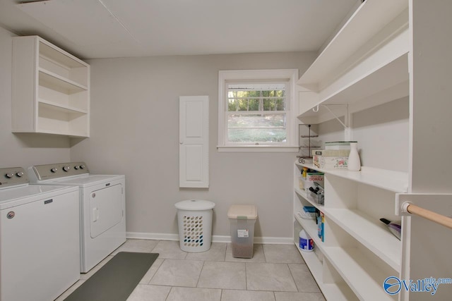 laundry room with light tile patterned flooring and washing machine and clothes dryer