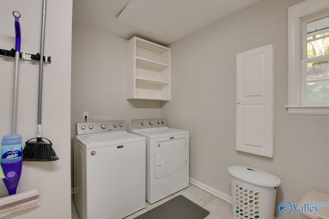 clothes washing area featuring light tile patterned floors and independent washer and dryer