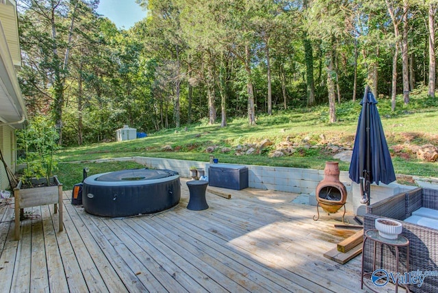 deck featuring an outdoor fireplace and a shed