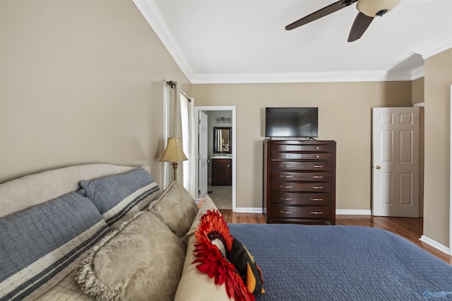 bedroom featuring baseboards, wood finished floors, and crown molding