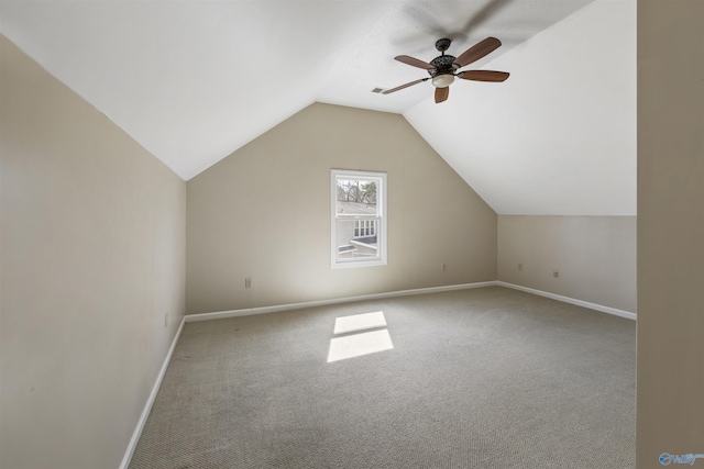 additional living space with baseboards, lofted ceiling, carpet, and ceiling fan