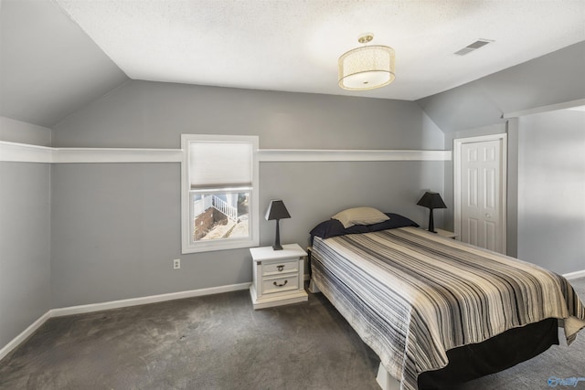 bedroom featuring dark colored carpet, visible vents, lofted ceiling, and baseboards