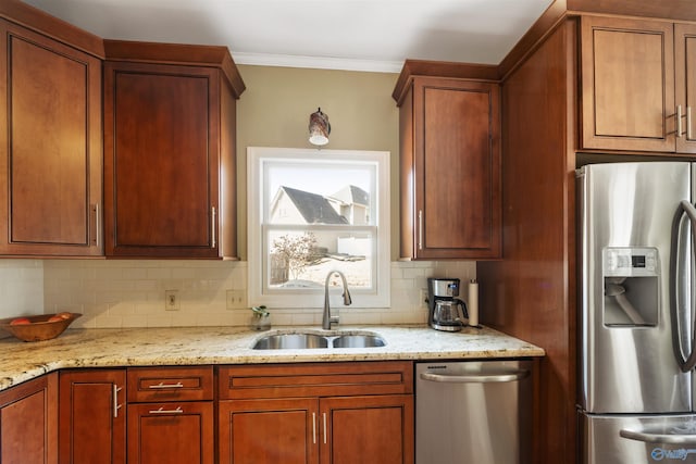 kitchen featuring ornamental molding, a sink, light stone counters, stainless steel appliances, and decorative backsplash