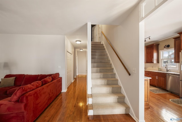 stairs featuring baseboards and hardwood / wood-style floors