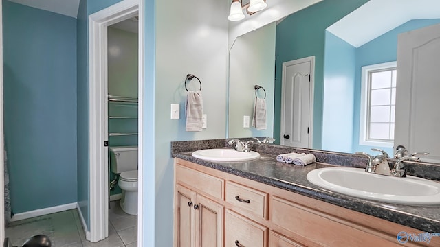 full bath with tile patterned flooring, a sink, lofted ceiling, and toilet