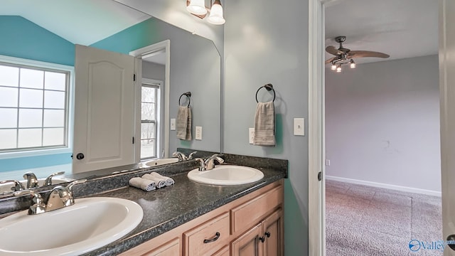 full bath with ceiling fan, a sink, baseboards, and double vanity