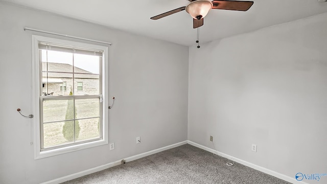 empty room with a ceiling fan, carpet, and baseboards