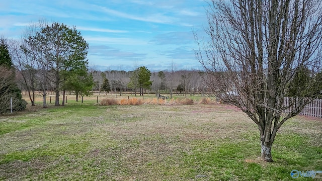 view of yard featuring a rural view and fence