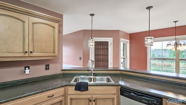 kitchen with dishwasher, dark countertops, a sink, and pendant lighting